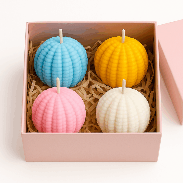 Jack and Rex Scented Textured Ball Candle Set featuring four ribbed spherical candles in blue, yellow, pink, and white, neatly packed in a pink gift box with shredded paper filling. Set of 4 ribbed round decorative candles in pastel pink, blue, yellow, and white, packed in a pink gift box with shredded paper – perfect for home decor or gifting