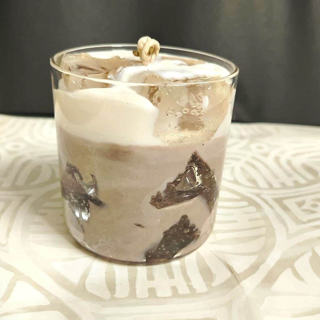 WhatsApp Image 2025-06-14 at 5.37.09 PM (2) A dessert-themed iced mocha swirl soy candle with whipped topping in a transparent glass jar.